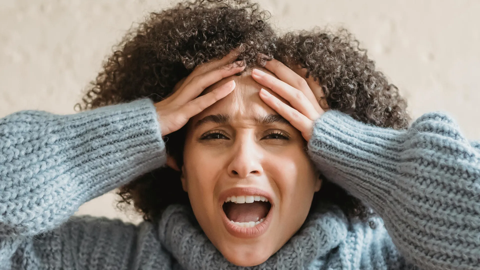 A young woman simply cannot control her anger. She appears to be on the brink of letting all her emotions spill out.