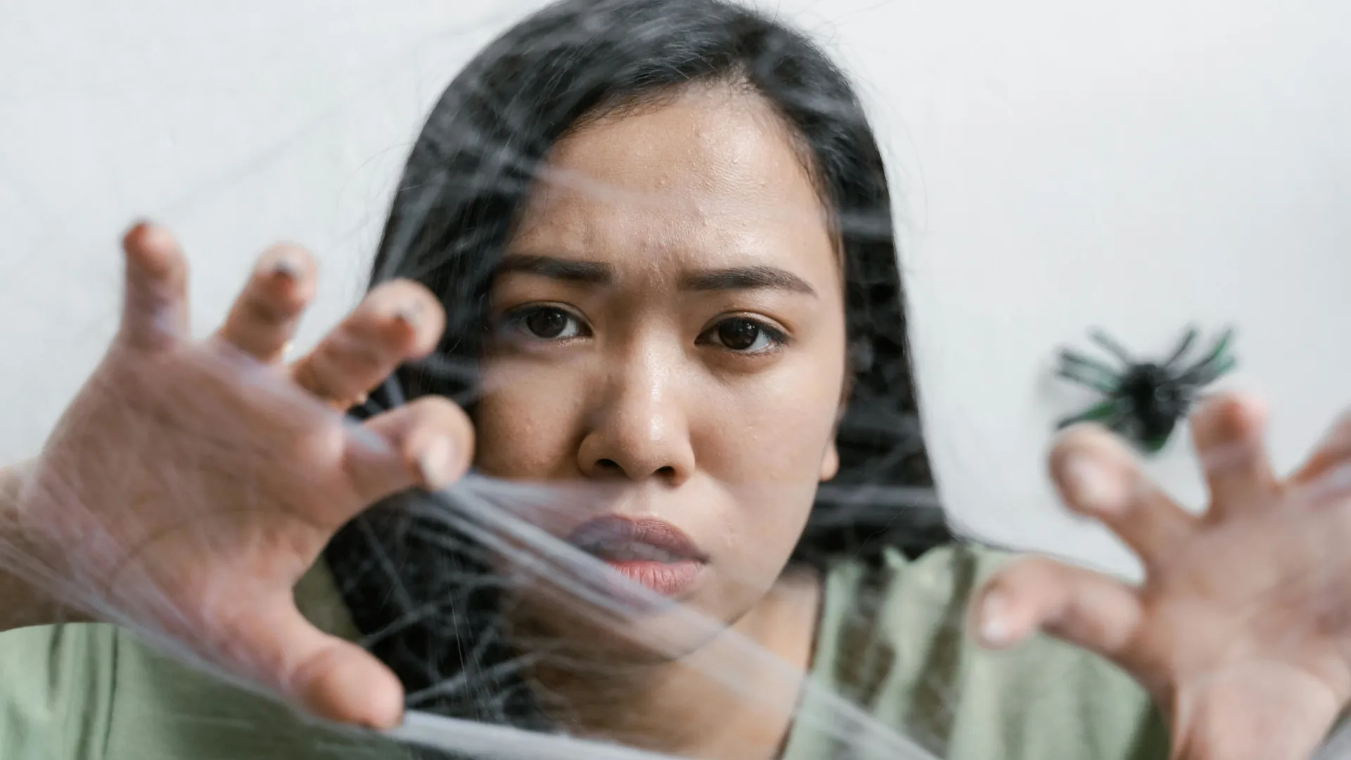 Young woman who is afraid of spiders.